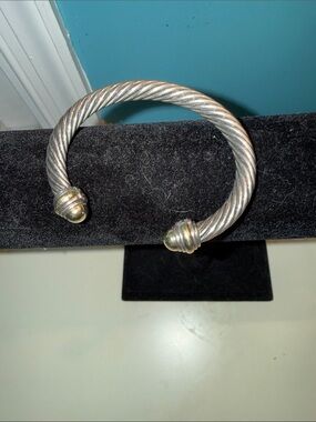 David Yurman Cable Classic bracelet in sterling silver with 14k gold dome tips.